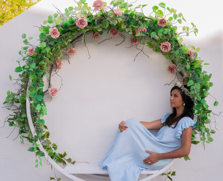 Lady with a blue dress in a flowers crown