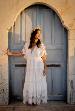 lady standing at the door at the sunset