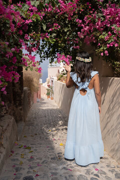 lady walking in a street with flowers