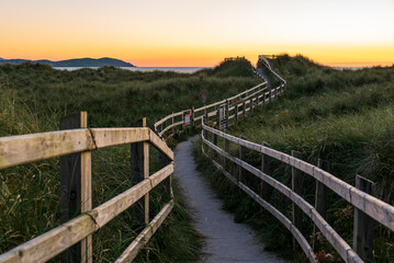Fototapeta na wymiar Wooden walkway with railing leading towards Dooey beach, County Donegal, Ireland