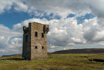 Scenic view of the Glencolumbkille signal tower under a dramatic cloudy sky, County Donegal, Ireland