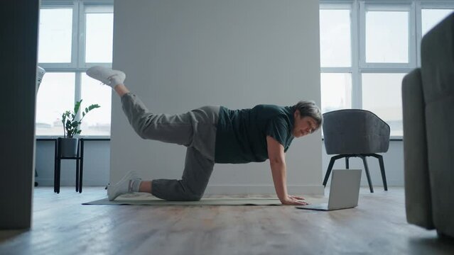 Home Fitness Workout Of Aged Woman, Senior Lady Doing Physical Exercise On Floor Of Living Room