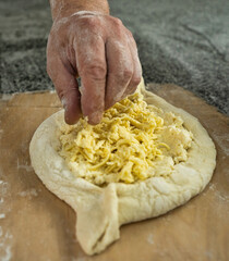 Batumi, Georgia - June 24, 2022: cooking adjarian khachapuri