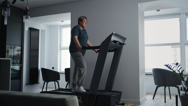 Cardio Training On Treadmill For Senior People, Woman With Excess Weight Walking For Losing Weight