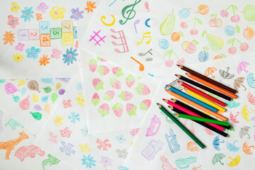 Drawing with colored pencils. Children drawing on a piece of paper.