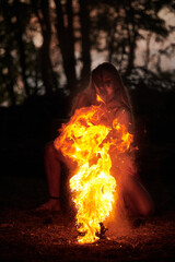Girl fire dancing performance at outdoor art festival, smooth movements of female artist dancing...