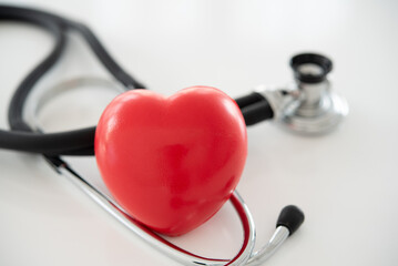 red heart with stethoscope at hospital. cardiovascular and heart health care concept.