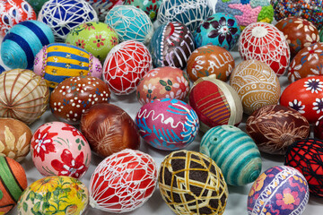 The entire frame filled with a composition of colorful Easter eggs with different patterns.