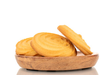 A few sweet cookies on a wooden plate, macro, isolated on a white background.