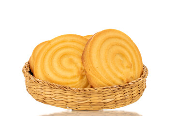 A few sweet cookies on a straw plate, macro, isolated on white background.