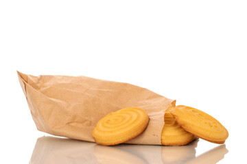 Several sweet cookies with paper bag, macro, isolated on white background.