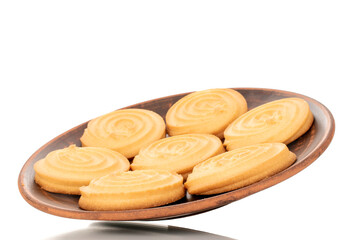 A few sweet cookies on a clay plate, macro, isolated on a white background.