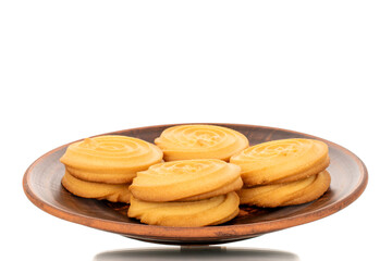 A few sweet cookies on a clay plate, macro, isolated on a white background.