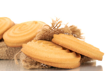 Several sweet cookies with jute bag, macro, isolated on white background.