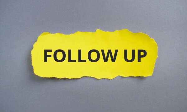 Mock up with torn paper FOLLOW UP text. sheet of yellow paper on a grey background. Business concept. Copy space