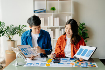 Obraz premium Asian businessman and woman people meeting in office. Employee brainstorm and work as team, plan and discuss project by point on paper and tablet.