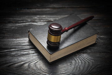 Judge gavel and book on the black table.