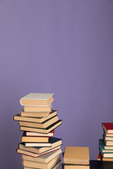 many books stacked on a purple background in the library of science knowledge