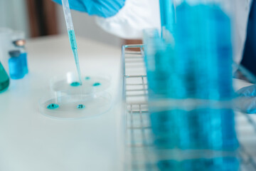 Female scientist researcher conducting an experiment working in the chemical laboratory.