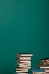 many books stacked on a table on a green background in the science knowledge library