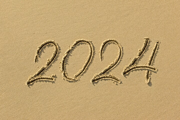 Inscription 2024 on the sand