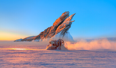 Hovercraft rides on Lake Baikal ice at sunset - Ogoy island on winter Baikal lake with transparent cracked blue ice at sunrise - Baikal, Siberia, Russia