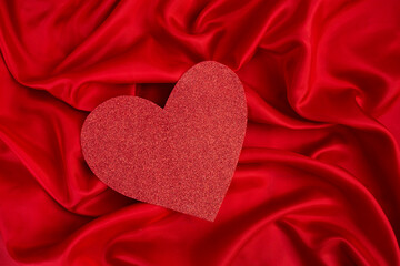 Red glitter heart with satin folds background