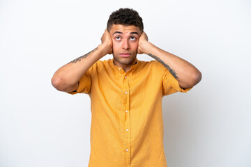 Young caucasian Brazilian man isolated on white background frustrated and covering ears