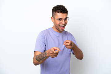 Young caucasian Brazilian man isolated on white background pointing to the front and smiling