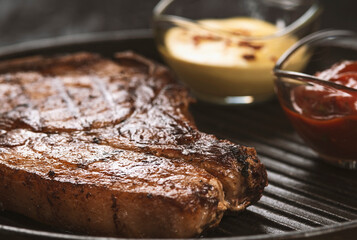 pork steak with vegetables in a black iron pan