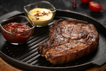 pork steak with vegetables in a black iron pan