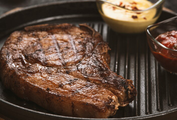 pork steak with vegetables in a black iron pan