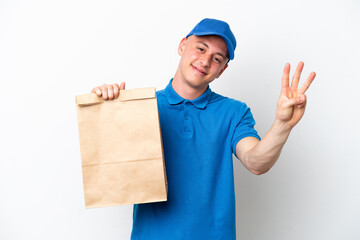 Young Brazilian man taking a bag of takeaway food isolated on white background happy and counting three with fingers