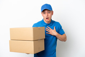 Young delivery Brazilian man isolated ops white background surprised and shocked while looking right