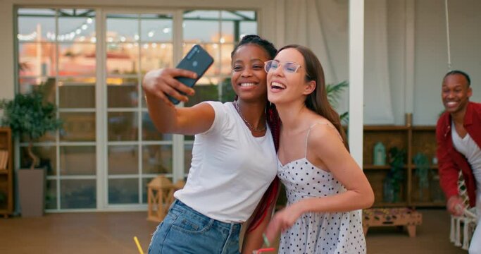 diverse beautiul women holding camera, taking selfie, friends running, joining them, men, women are looking at camera, smiling and posing, slow motion, friendship happiness free spare time slow motion