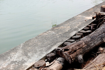 Fototapeta premium Fragment of the concrete embankment. Concrete wall. Side view.