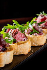 bruschetta with roast beef and cheese on plate