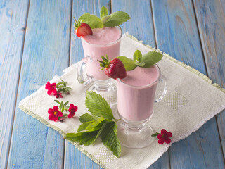 strawberry smoothie with yogurt on a wooden background.