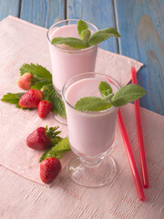 strawberry smoothie with yogurt on a wooden background.