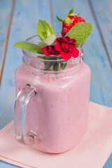 strawberry smoothie with yogurt on a wooden background.