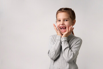 Happy child girl with open hands. Surprised girl portrait