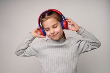 Girl listening music with headphones over white background