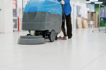 Fototapeta premium cleaning floor with machine
