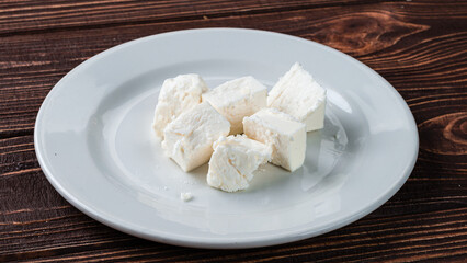 Pieces of Feta cheese in a ceramic plate.