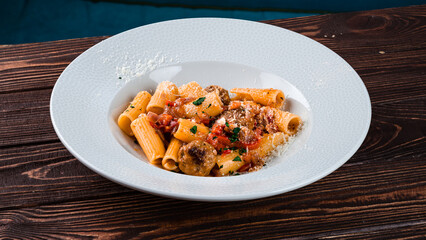 Dinner pork meatballs with pasta, cheese and sweet pepper.