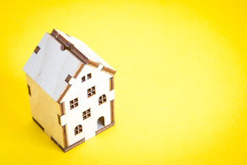 a small house on a yellow background. mortgage. credit. buying a home. realtor