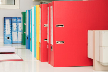 Sideview of office ordners in different colors on a laboratory table