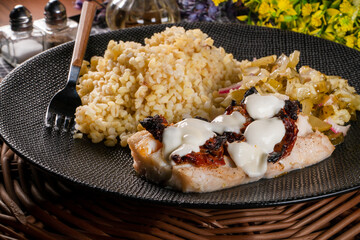 Roasted cod fish with bulgur.