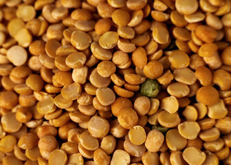 Yellow dry peas background texture. Split dried peas closeup photo