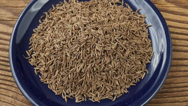 Aromatic roman cumin in a small bowl on the table